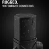 A close-up of a black, rugged, watertight connector with water droplets on it, set against a dark background. Podgląd zdjęcia produktu