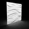 A white 3D wall panel with a wavy pattern is shown against a black background. Produktbild-Vorschau