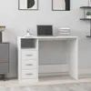 A white desk with drawers and a laptop on it, placed in a room with artwork on the wall. Produktbild-Vorschau