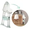 A high chair is shown in two views: one close-up and one in a kitchen setting, demonstrating its folded state. Produktbild-Vorschau