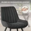 Close-up of a black upholstered chair with white stitching, with a circular inset showing a hand pressing into foam. Voir les images du produit