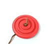 A red, circular swing seat with a braided rope attached, isolated on a white background. Anteprima dell’immagine prodotto