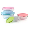 A set of glass bowls with colorful lids on a white background. Voir les images du produit
