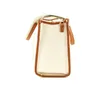 A side view of a cream-colored handbag with brown trim, set against a white background. Anteprima dell’immagine prodotto