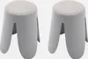 Two identical grey stools with textured light grey seats are shown side-by-side against a white background. Produktbild-Vorschau