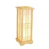 A tall, rectangular lantern with a wooden frame and parchment-like panels, lit from within. Náhled obrázku produktu