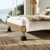 A bed in a room with large windows overlooking a natural landscape. Produktbild-Vorschau