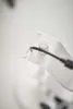 A close-up of a white electronic device with a black cable plugged into it. Produktbild-Vorschau