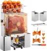 A commercial orange juicer with a basket of oranges on top, and various accessories laid out next to it. Produktbild-Vorschau