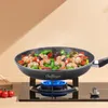 A frying pan with food being cooked on a gas stove. Produktbild-Vorschau