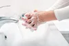 Hands being washed with soap and water in a sink. Náhľad obrázku produktu