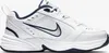 A white Nike Air Monarch IV sneaker with navy accents, shown from the side against a white background. Náhled obrázku produktu