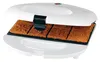 A waffle maker with four square waffles inside. Produktbild-Vorschau