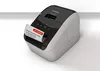 A Brother QL-800 label printer is shown on a white and light gray background, printing a label. Produktbild-Vorschau