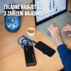 A person is using a laptop while a power bank charges a phone on a wooden desk. A decorative lamp and a cup of coffee are also on the desk. Produktbild-Vorschau
