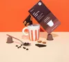 A coffee cup with coffee capsules, chocolate, and coffee beans arranged around it. Anteprima dell’immagine prodotto