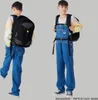 Two views of a boy wearing a backpack and denim overalls, presented against a plain background. Anteprima dell’immagine prodotto