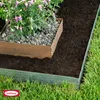 A garden bed with a plant in a metal planter, bordered by dark soil and green lawn edging. Produktbild-Vorschau