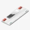 A white mechanical keyboard with red and green accents, lying on a white background. Produktbild-Vorschau