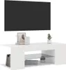 A white TV stand with decorative items on top and books and plants on the shelf below, with a black TV screen mounted on the wall above. Náhľad obrázku produktu