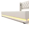 A white upholstered bed frame with integrated LED lighting along the base. Voir les images du produit
