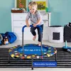 A young boy is jumping on a small trampoline in a child's room. Anteprima dell’immagine prodotto