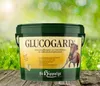A bucket of horse feed with a background of green grass and bokeh lights. Produktbild-Vorschau