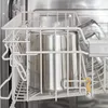 A close-up view of a stainless steel pot inside a dishwasher rack. Produktbild-Vorschau