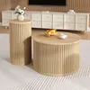 Two round wooden tables are placed on a rug in a living room setting, with a credenza and TV in the background. Voir les images du produit