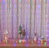 A festive display of Christmas decorations on a shelf, including string lights, miniature trees, a lantern, and a vase. Produktbild-Vorschau