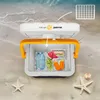 A portable cooler filled with food and drinks on a sandy beach with waves in the background. Anteprima dell’immagine prodotto