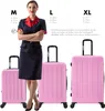 A woman in a uniform stands next to three pink suitcases of different sizes. Náhľad obrázku produktu