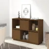 A brown wooden sideboard with multiple compartments, some open and some closed with doors. Decorative items and dishes are placed on and inside the sideboard. A framed picture is leaning against the wall behind it. Náhled obrázku produktu