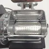 Close-up of the hopper and grinding cylinder of an electric cheese grater. Anteprima dell’immagine prodotto
