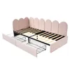 A pink upholstered bed frame with wooden slats and two wire drawers pulled out from underneath. Podgląd zdjęcia produktu