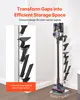 A vacuum cleaner stand with various attachments is shown next to a wall, with text overlays highlighting its features. Produktbild-Vorschau