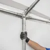 A person wearing gloves is assembling a tent pole. Produktbild-Vorschau