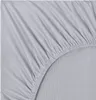 A close-up view of a grey fitted sheet, showing the texture and elasticized edge. Produktbild-Vorschau
