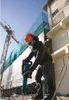 A construction worker using a jackhammer on a building site. Anteprima dell’immagine prodotto