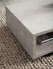 A close-up of a modern, rectangular coffee table with a marble-like finish, placed on a textured rug. Anteprima dell’immagine prodotto
