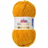 A ball of yellow yarn with a label. Podgląd zdjęcia produktu