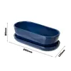 A dark blue oval planter with a matching saucer, shown with dimensions indicated by text overlays. Náhled obrázku produktu