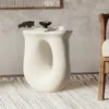 A modern living room setting with a unique white side table. Náhled obrázku produktu