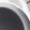 A close-up view of the edge of a round pan with a patterned surface. Voir les images du produit