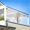 A couple enjoys drinks on a balcony protected by a clear PVC tarp. Náhled obrázku produktu