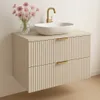 A bathroom vanity with a sink and faucet, decorated with a vase of flowers. Náhled obrázku produktu