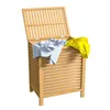 A wooden laundry basket with its lid open, containing some clothes. Anteprima dell’immagine prodotto