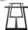 A close-up, low-angle view of black metal table legs against a white background. Anteprima dell’immagine prodotto