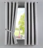 A window with gray curtains, one of which is tied back with a fabric strap. A pink vase and a white decorative object are on the windowsill. Produktbild-Vorschau