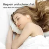 A woman is sleeping in bed with earbuds in her ears. Produktbild-Vorschau